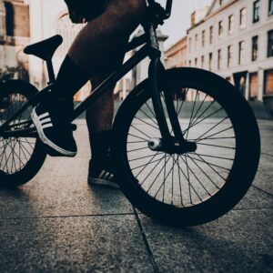 Person on a BMX bike in an urban setting at sunset.