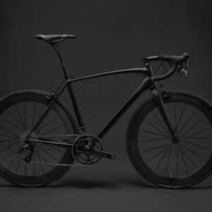 Sleek black road bike against a dark background.